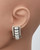Coil jewelry displayed on a mannequin, elegant hoop shape and artisanal finish. View Product Image
