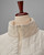 Cream quilted poncho with zipper, displayed on a mannequin. View Product Image