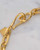 Featuring a handmade hook clasp, this etched gold necklace offers both elegance and secure wear. View Product Image