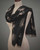 Black leaf scarf styled as a wrap on mannequin, showcasing a reversible ginkgo pattern. View Product Image