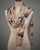 Black and white reversible scarf with a ginkgo leaf design draped on a mannequin. View Product Image