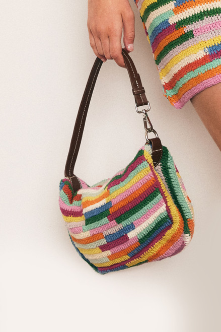 A burst of colour and craft, this cotton crochet mini bag features a zipper closure with leather tassel and straps. Lightweight and artisanal, it’s the perfect playful companion for casual days and festival nights.
