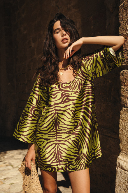 The Zebra Shift Mini Dress in olive is bold, structured, and effortlessly playful. Cut from crisp polyester taffeta in a custom Bohemian Traders print, it features a round neckline, flared sleeves, and an easy shift silhouette. Just add boots or strappy sandals for a standout day-to-night look. The Zebra Shift Mini Dress in olive is bold, structured, and effortlessly playful. Cut from crisp polyester taffeta in a custom Bohemian Traders print, it features a round neckline, flared sleeves, and an easy shift silhouette. Just add boots or strappy sandals for a standout day-to-night look.
