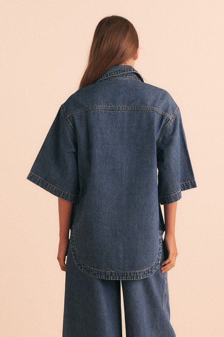 A cool classic, this oversized denim shirt channels effortless casual with a soft curve hem, chest patch pockets, and short sleeves. Made from premium cotton denim with just the right weight, it’s a wardrobe essential that pairs beautifully with everything from shorts to tailored pants.