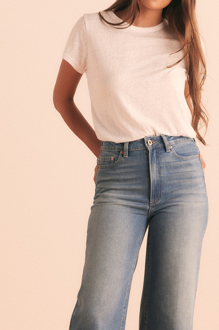 Wide-legged and cropped with a raw hem, these stretch denim jeans blend comfort and cool. A fitted waist and relaxed, flattering silhouette make them an easy-to-style staple with just the right hint of lived-in edge.
