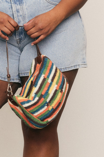 Fresh, fun, and handmade - this cotton crochet mini bag with leather accents brings artisanal charm and effortless style to your everyday wardrobe.