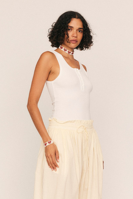 A modern wardrobe essential reimagined with quiet confidence. The Scoop Neck Tank is cut from soft, premium ribbed cotton with just the right amount of stretch, offering a figure-skimming silhouette that flatters every shape. With a rounded scoop neckline, sleek self-binding, and functional button detailing, it transitions effortlessly from layering piece to stand-alone staple.