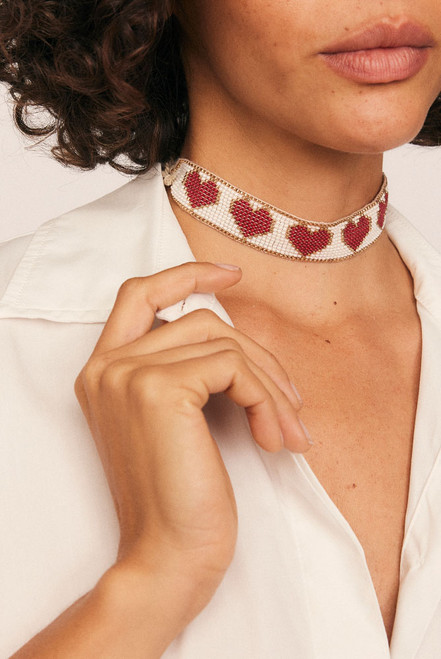 Romantic with a playful edge, the Loveheart Beaded Choker is handcrafted in a vibrant heart motif using red, gold, and white glass beads. Woven with care and artistry, this statement piece sits delicately at the neckline—adding a bold, personal touch to any look.