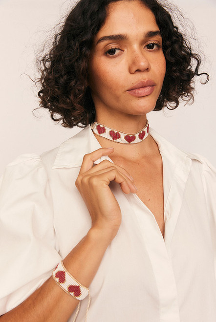 Romantic with a playful edge, the Loveheart Beaded Choker is handcrafted in a vibrant heart motif using red, gold, and white glass beads. Woven with care and artistry, this statement piece sits delicately at the neckline—adding a bold, personal touch to any look.