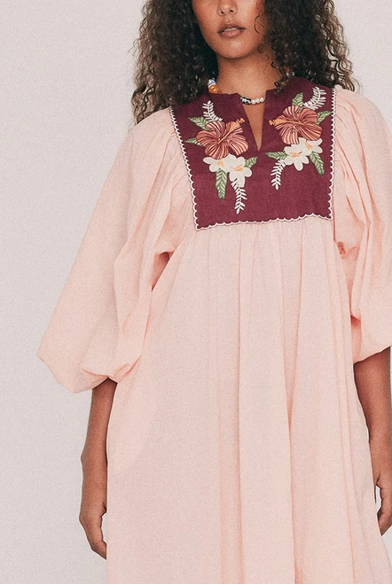Cut from soft cotton voile, this boho coral maxi dress falls loose from an embroidered linen bib. Hibiscus and frangipani illustrations, drawn by hand in our Central Coast studio, trace the yoke. A split V neckline and long sleeves gathered at the cuff ensure ease of wear, while pockets set into the side seams provide practicality. Made for hot days that turn into breezy evenings, for a long lunch or a week somewhere warm. Designed from a 6 to a 22.