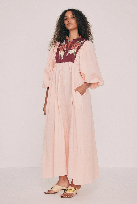 Cut from soft cotton voile, this boho coral maxi dress falls loose from an embroidered linen bib. Hibiscus and frangipani illustrations, drawn by hand in our Central Coast studio, trace the yoke. A split V neckline and long sleeves gathered at the cuff ensure ease of wear, while pockets set into the side seams provide practicality. Made for hot days that turn into breezy evenings, for a long lunch or a week somewhere warm. Designed from a 6 to a 22.