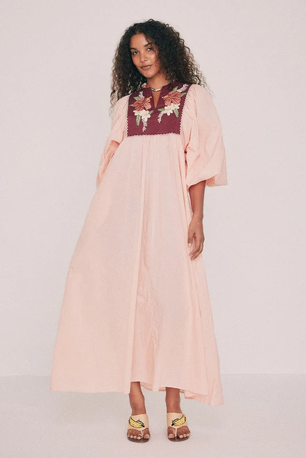 Cut from soft cotton voile, this boho coral maxi dress falls loose from an embroidered linen bib. Hibiscus and frangipani illustrations, drawn by hand in our Central Coast studio, trace the yoke. A split V neckline and long sleeves gathered at the cuff ensure ease of wear, while pockets set into the side seams provide practicality. Made for hot days that turn into breezy evenings, for a long lunch or a week somewhere warm. Designed from a 6 to a 22.