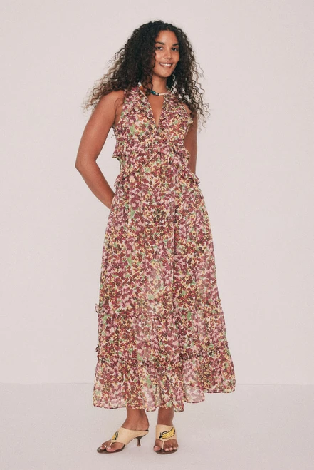 Cut from soft crepe georgette, this printed maxi dress skims the bust and waist before loosening through the hip. Ruffles run beneath the bust, at the waist and along the hem, while a low V neckline ties at the front with self rouleau. The Ola ditsy floral was drawn by hand in our Central Coast studio. Pockets sit in the side seams. A wedding guest dress that will also carry a long lunch. Pair with a vintage platform and chandelier earrings. Designed from a 6 to a 22.