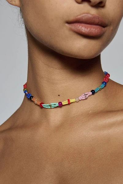 Hand beaded in a twisted multi-colour design, this artisanal choker sits close at the neck at forty centimetres. It is what finishes a plain linen dress for dinner. One size.