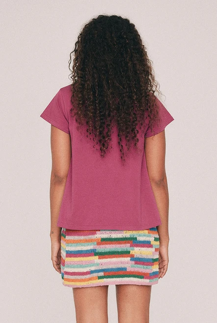 This fuchsia tee has a relaxed swing silhouette with cap sleeves. Machine washable and quietly indispensable: wear it with the crochet skirt all summer. Designed from a 6 to a 22.