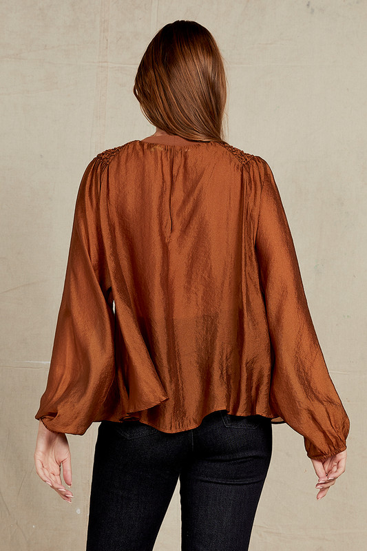 Elevate your wardrobe with our Bronze Crew Neck Blouse. Effortlessly chic, this long-sleeve blouse combines classic design with modern flair. The shirring detail on the front adds texture and dimension while tempering the ethereal sheerness. Wear yours with denim and strappy sandals.