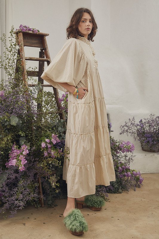 Celebrate the arrival of summer with Bohemian Traders famed Boho Midi Dress. Cut from breathable cotton and patterned with lemon and cafe stripes, it's relaxed sillhouette makes it perfect for easy days spent seaside. Pintucks to the yoke and tiers finished with ruffles make this striped dress just as suited to lunch at the resort as covering up when heading to and from the beach.

Circular product. Natural fibre.