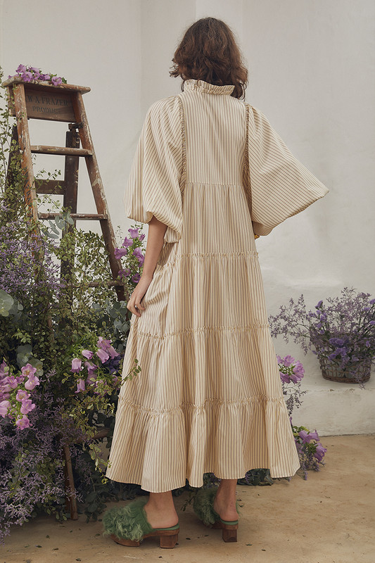 Celebrate the arrival of summer with Bohemian Traders famed Boho Midi Dress. Cut from breathable cotton and patterned with lemon and cafe stripes, it's relaxed sillhouette makes it perfect for easy days spent seaside. Pintucks to the yoke and tiers finished with ruffles make this striped dress just as suited to lunch at the resort as covering up when heading to and from the beach.

Circular product. Natural fibre.