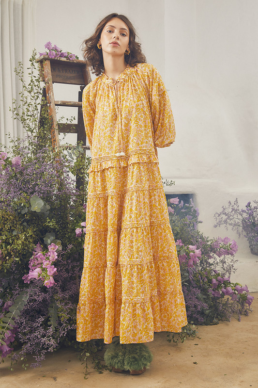 From the honey tones to the fluttery tiers, Bohemian Traders Ruffle Neck Maxi Dress is destined to be the centre of attention. It's made from cotton voile that's printed with 70's inspired florals and has tonal ties to the neck. Pair yours with tan accessories for day and golden heels for night.