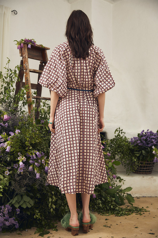Bohemian Traders best selling Pleated Neck Midi Dress is made from soft cotton poplin patterned with cubist inspired print. The feminine bodice cinches with a rope belt at the waist before falling to a full skirt. Ground yours with boots for the cooler months.