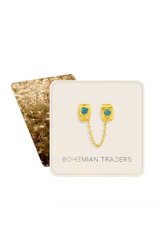 These gold toned earrings are comprised of turquoise studs adorned with a dainty chain. Stack them with other pieces in the collection.
