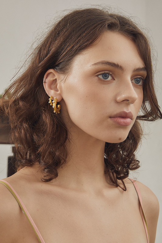 This jewellery capsule echoes the modernity and minimalism of our calssic product offering. These hoop earrings are handcrafted from gold-tone nano brass and adorned with pearls. Wear them stacked with other pieces in the collection.