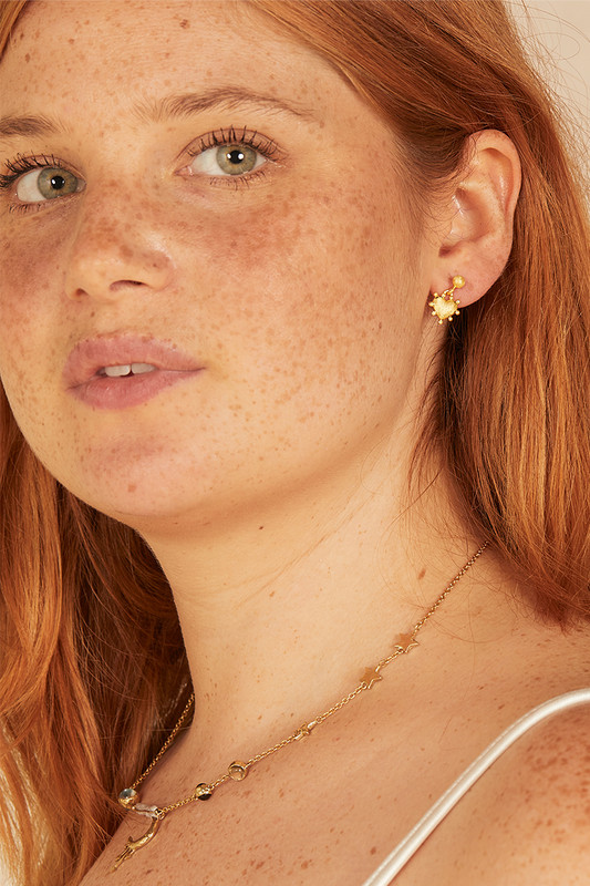 These dainty heart earrings are timeless and understated, so they're the perfect everyday signature. They're handmade from gold-toned nano brass and adorned by small baubles that hilight the heart shape. Wear them stacked with similar studs from the collection.