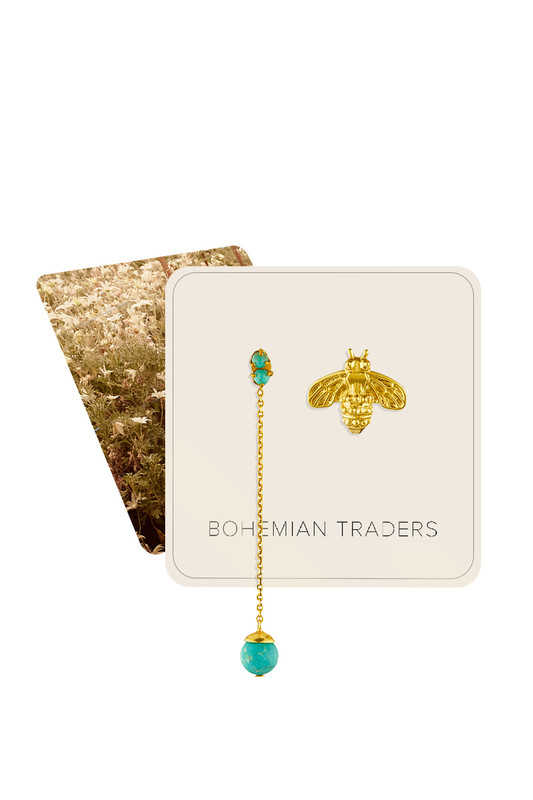 Bohemian Traders incorporates playful motifs into its collections to re-inspire the fun of dressing up. This Bee-Tanical earring set features a single bee stud that has been hand cast and plated in gold toned nano brass. It's partner features a slim chain grounded by genuine turquoise details that swing with every step.