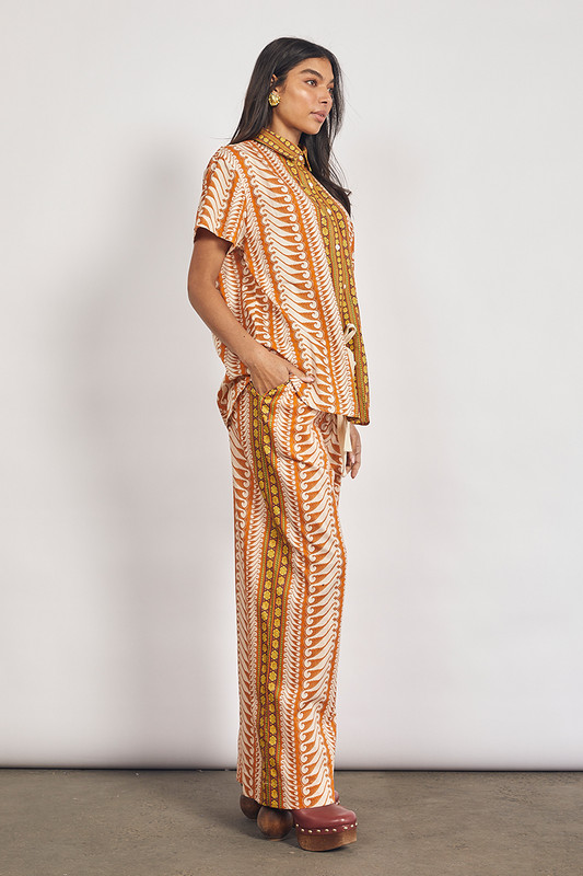 Bohemian Traders elastic waist pants are meant to be worn with the coordinating shirt but look just as chic with a crew neck tee and slides. Made from cotton, they're printed with a swirling tonal motif and have a drawstring waistband and wide, breezy legs.