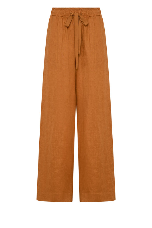 These rust linen wide-leg pants combine effortless comfort with elevated tailoring. The elasticated waist with drawcord and side pockets create a laid-back yet polished silhouette, perfect for both sunlit mornings and twilight dinners. Wear with the Rust Billow Shirt for easy, relaxed style.