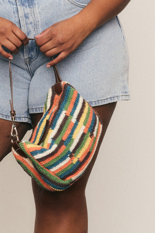 Fresh, fun, and handmade - this cotton crochet mini bag with leather accents brings artisanal charm and effortless style to your everyday wardrobe.