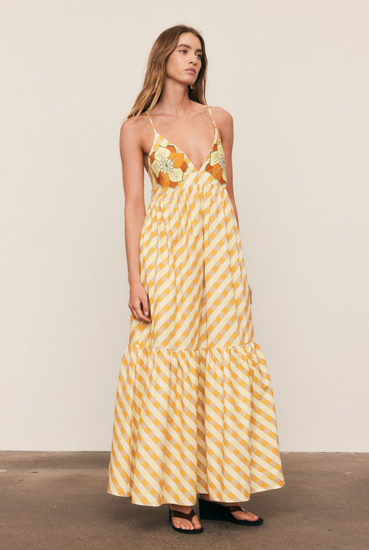 A best-selling silhouette reimagined in sunset hues, the Gingham Slip Dress is crafted from mid-weight cotton with embroidered appliqué detailing. Featuring a fitted bodice, full skirt and gathered back, it flatters with ease and movement. Made from natural fibre for breathable comfort, it’s timeless, feminine, and destined to sell out fast.