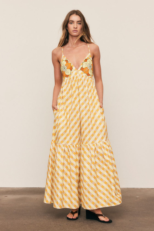 A best-selling silhouette reimagined in sunset hues, the Gingham Slip Dress is crafted from mid-weight cotton with embroidered appliqué detailing. Featuring a fitted bodice, full skirt and gathered back, it flatters with ease and movement. Made from natural fibre for breathable comfort, it’s timeless, feminine, and destined to sell out fast.