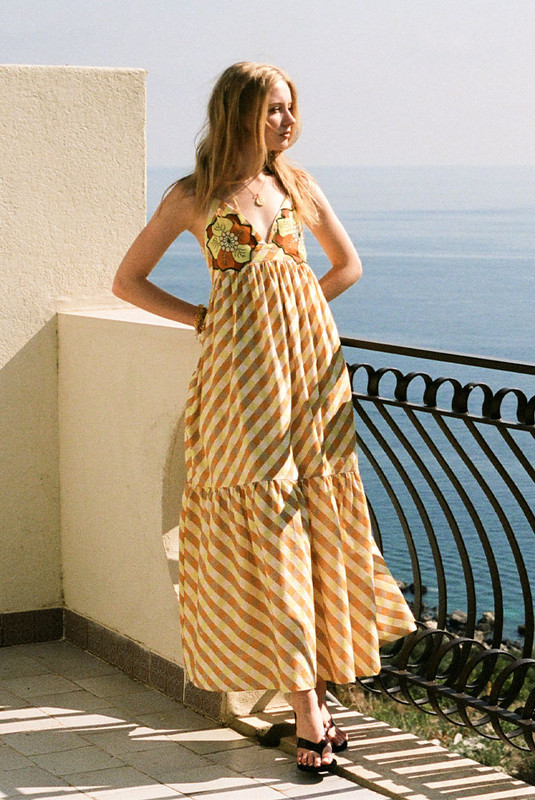 A best-selling silhouette reimagined in sunset hues, the Gingham Slip Dress is crafted from mid-weight cotton with embroidered appliqué detailing. Featuring a fitted bodice, full skirt and gathered back, it flatters with ease and movement. Made from natural fibre for breathable comfort, it’s timeless, feminine, and destined to sell out fast.