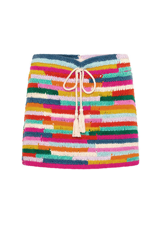 This hip sitting mini skirt will serve you well on sunny vacations for years to come. Made by hand from multi coloured cotton yarn, it has a drawcord and tassels to the centre front and looks equally as great with sandals, slides and boots. Wear yours with the matching top for maximum style mileage. 