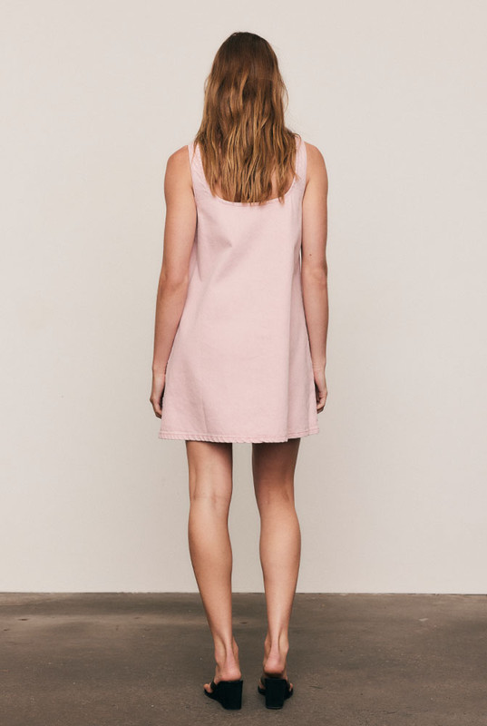 Easy, timeless, and beautifully constructed, the Scoop Neck Mini Dress is cut from premium rigid denim in a soft Ice Pink wash. The A-line silhouette and scoop neckline create fluid, flattering movement. Machine washable and naturally breathable, it’s a core piece that balances comfort with quiet sophistication.
