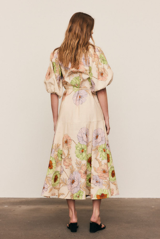 This premium linen blend midi dress is a study in effortless volume and artful print. Intended for a fluid, loose fit, the silhouette is balanced by a classic collar and a smooth button-down front, allowing the fabric to drape beautifully. Voluminous puff sleeves and a flowing midi skirt showcase the custom-designed floral placement print. This is a graceful, seasonless piece that combines comfort with sophistication, ensuring ultimate longevity in your modern capsule wardrobe.