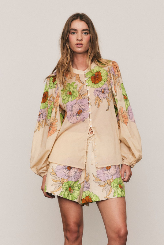 The Venice Puff Sleeve Blouse captures bohemian artistry in soft cotton voile, adorned with Bohemian Traders’ in-house Venice Cream placement print. A mandarin collar and voluminous sleeves create graceful proportion, while the relaxed fit offers ease and movement. Light and effortless, it’s the perfect blouse for sun-drenched days or elevated evenings alike.