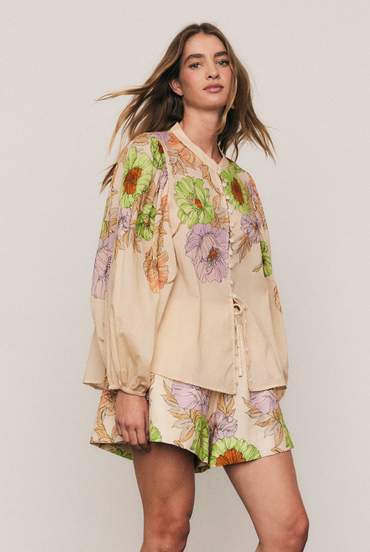 The Venice Puff Sleeve Blouse captures bohemian artistry in soft cotton voile, adorned with Bohemian Traders’ in-house Venice Cream placement print. A mandarin collar and voluminous sleeves create graceful proportion, while the relaxed fit offers ease and movement. Light and effortless, it’s the perfect blouse for sun-drenched days or elevated evenings alike.