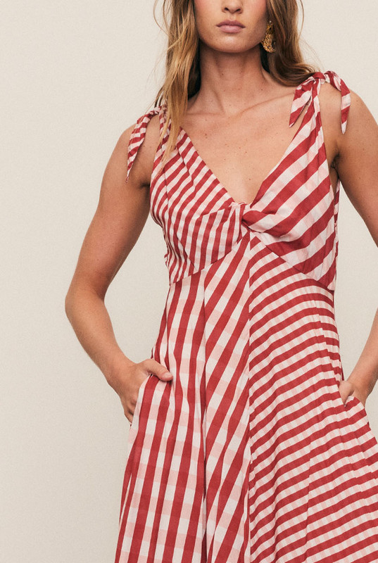 A statement of fluid artistry, the Gingham Scarf Dress is crafted from luxurious soft modal in a custom scarf-print gingham. Its twisted bust, adjustable ties, and sweeping hanky hem create movement and grace. Light as air and endlessly elegant, it’s a festive-season favourite made for weddings, New Year’s soirées, and sunset celebrations.