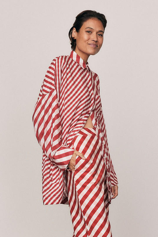The Gingham Check Shirt is cut from lightweight modal and spliced with Bohemian Traders’ custom print for a bold, elevated finish. The oversized silhouette and classic collar make it endlessly versatile. Pair with the matching Crop Flare Pant for a coordinated festive look defined by natural comfort and modern ease.