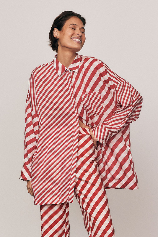 The Gingham Check Shirt is cut from lightweight modal and spliced with Bohemian Traders’ custom print for a bold, elevated finish. The oversized silhouette and classic collar make it endlessly versatile. Pair with the matching Crop Flare Pant for a coordinated festive look defined by natural comfort and modern ease.