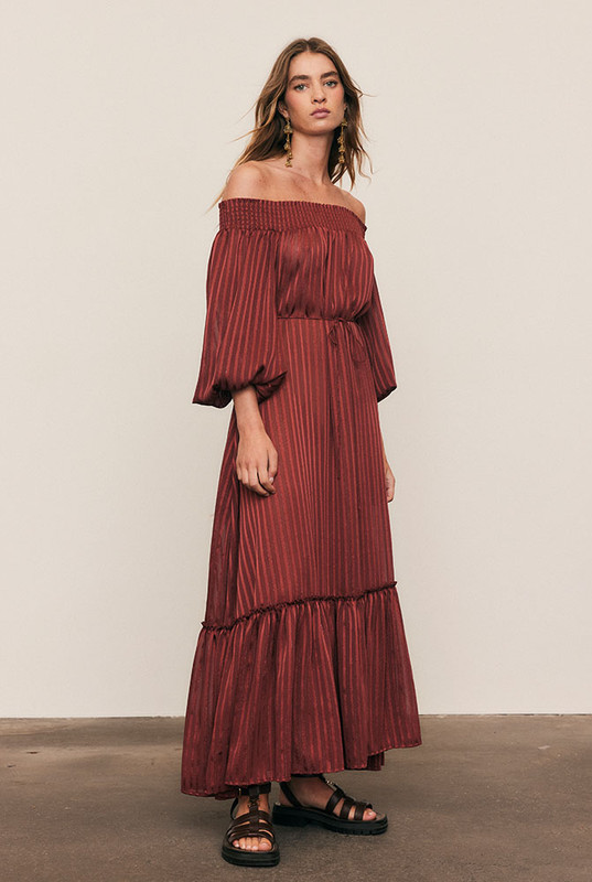 Luminous and luxurious, the Lurex Maxi Dress is crafted from a custom-dyed lurex-stripe blend, developed exclusively to Bohemian Traders’ exacting standards. Its off-shoulder neckline, voluminous balloon sleeves, and waist tie create a silhouette of effortless drama. Light-catching and fluid, it moves like liquid sunlight - a true statement of artistry and occasion-ready elegance.