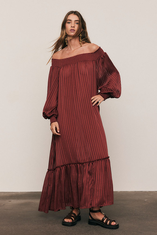 Luminous and luxurious, the Lurex Maxi Dress is crafted from a custom-dyed lurex-stripe blend, developed exclusively to Bohemian Traders’ exacting standards. Its off-shoulder neckline, voluminous balloon sleeves, and waist tie create a silhouette of effortless drama. Light-catching and fluid, it moves like liquid sunlight - a true statement of artistry and occasion-ready elegance.
