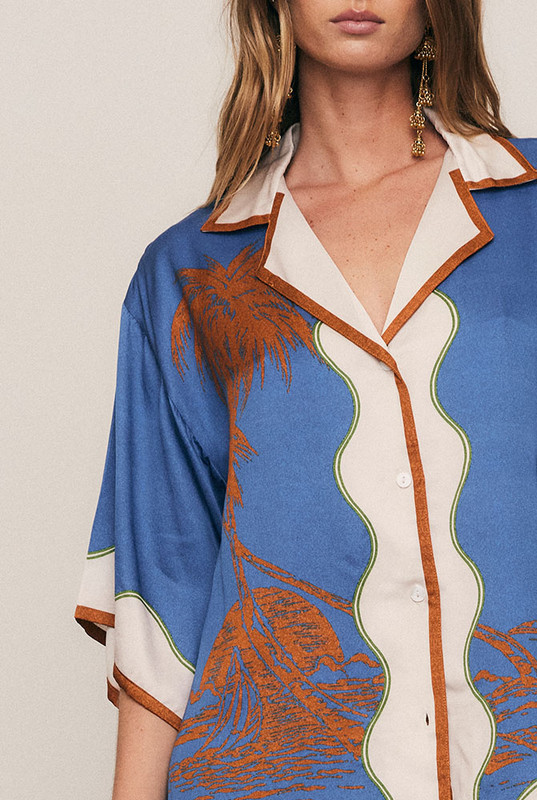 Effortlessly refined, the Kauai Short Sleeve Shirt is crafted from silky viscose satin in Bohemian Traders’ exclusive palm placement print. Featuring a relaxed fit, camp collar and wide sleeves, it drapes beautifully with subtle shine. Pair with the matching Kauai Maxi Skirt for a cohesive, statement-making summer set that moves with fluid ease.