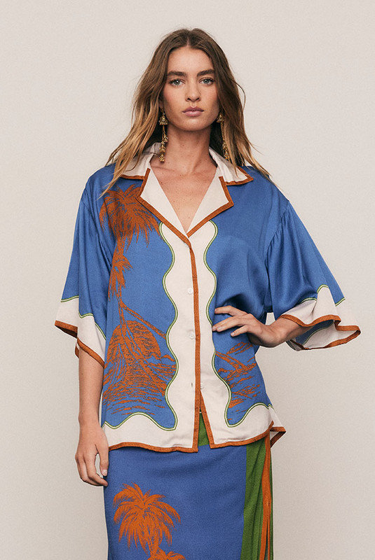 Effortlessly refined, the Kauai Short Sleeve Shirt is crafted from silky viscose satin in Bohemian Traders’ exclusive palm placement print. Featuring a relaxed fit, camp collar and wide sleeves, it drapes beautifully with subtle shine. Pair with the matching Kauai Maxi Skirt for a cohesive, statement-making summer set that moves with fluid ease.