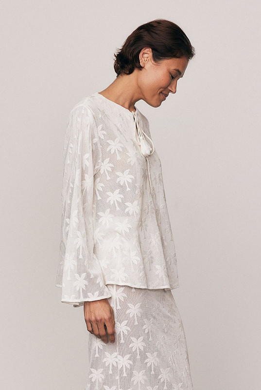 Softly sculptural, the Cotton Lace Swing Top is crafted from a premium cotton-blend knit lace featuring an intricate palm motif. With voluminous sleeves and a gentle swing hem, it blends texture and femininity with ease. A statement in craftsmanship and comfort. Pair with the matching Cotton Lace Maxi Skirt for head-to-toe elegance.