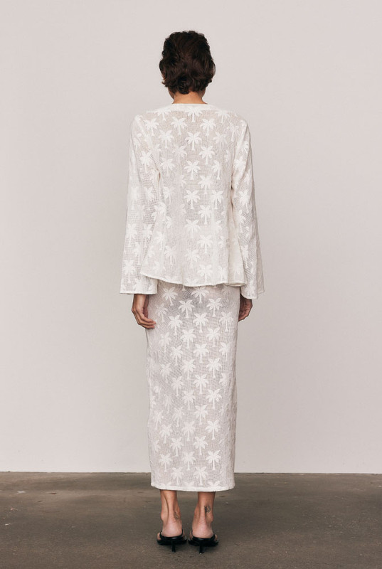 The Cotton Lace Maxi Skirt captures quiet elegance in motion. Cut from a premium cotton-blend knit lace with a refined palm motif, it’s designed with an elasticated waist and fluid drape that flatters effortlessly. Wear it with the matching Cotton Lace Swing Top for a feminine, textural look that feels timeless and beautifully modern.