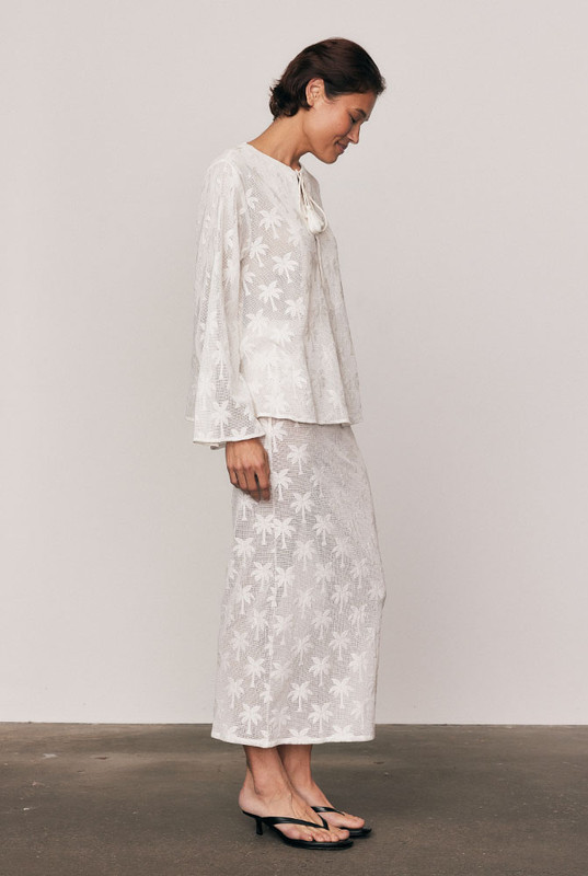 The Cotton Lace Maxi Skirt captures quiet elegance in motion. Cut from a premium cotton-blend knit lace with a refined palm motif, it’s designed with an elasticated waist and fluid drape that flatters effortlessly. Wear it with the matching Cotton Lace Swing Top for a feminine, textural look that feels timeless and beautifully modern.