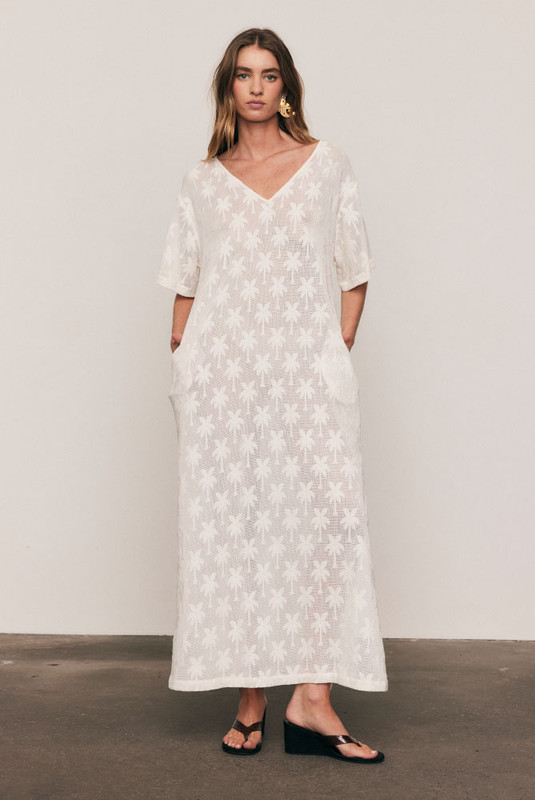Artful and effortless, the Cotton Lace Tee Dress is crafted from a premium knitted cotton-blend lace featuring Bohemian Traders’ signature palm motif. With a relaxed, oversized silhouette and wide short sleeves, it drapes beautifully for summer days. A breathable natural-fibre piece designed for comfort, texture, and graceful movement under the sun.